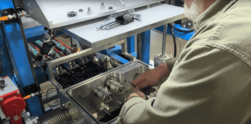 Technician working on a custom argon gas leak test system